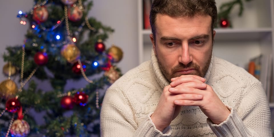sadmanchristmasfamilyshutterstock525688093