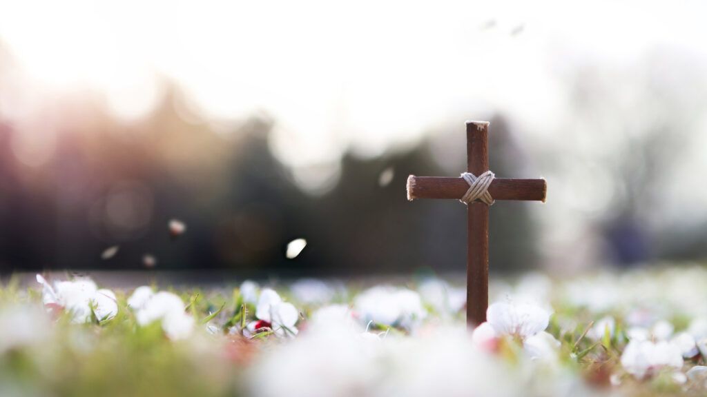 woodencrosssurroundedbyspringflowerswithlentquotes1024x576jpgoptimal